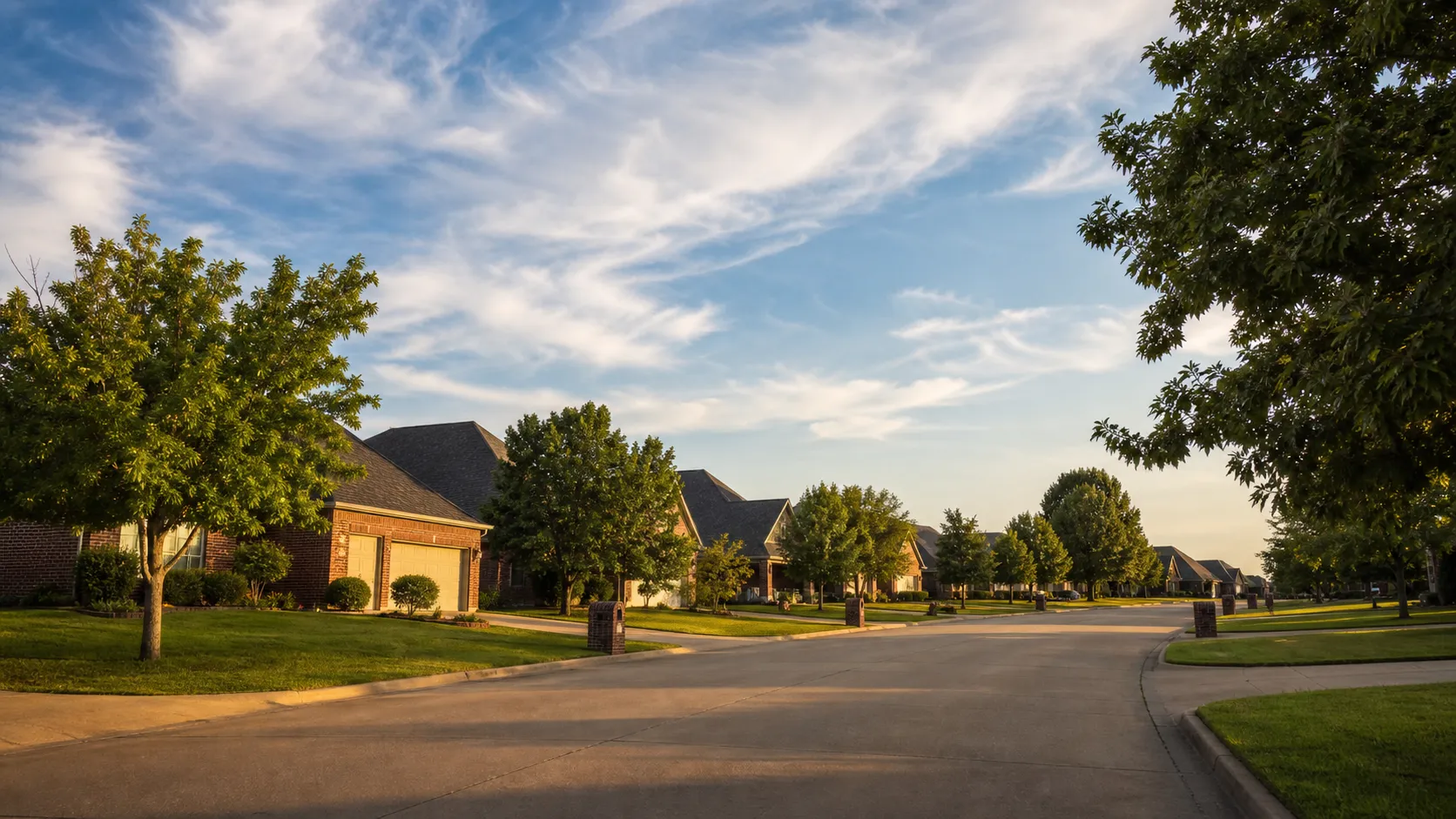Newer brick homes on a quiet Broken Arrow street on a summer morning